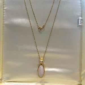 Fashion pendant with oval cut Opal and pear shaped accent diamond.
